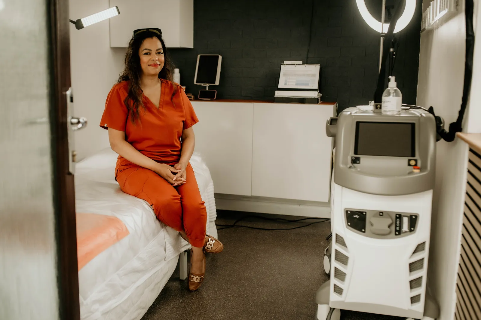 Vanessa in the treatment room at WILD beside the Candela laser